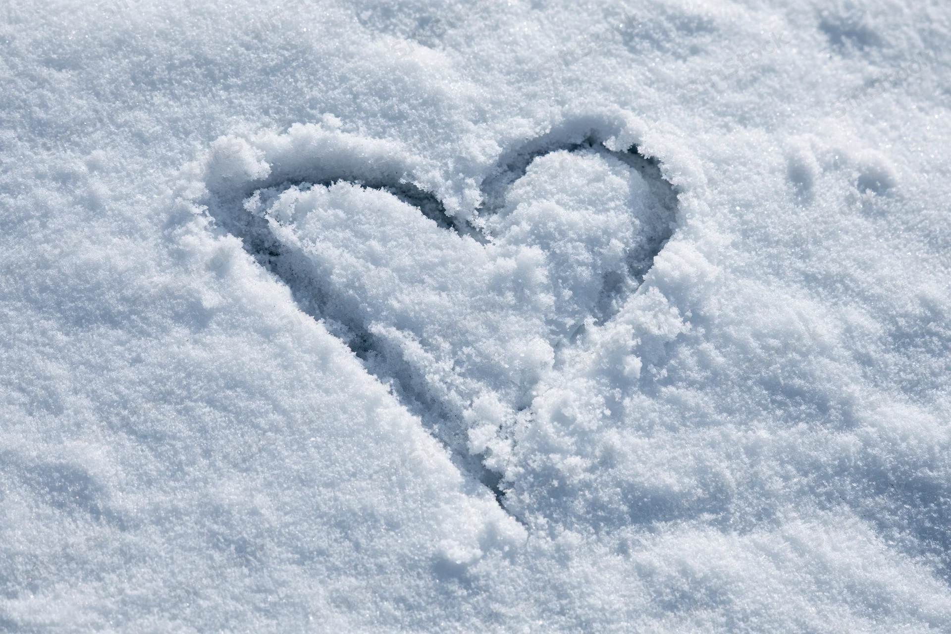 Heart shape drawn in fresh snow outdoors