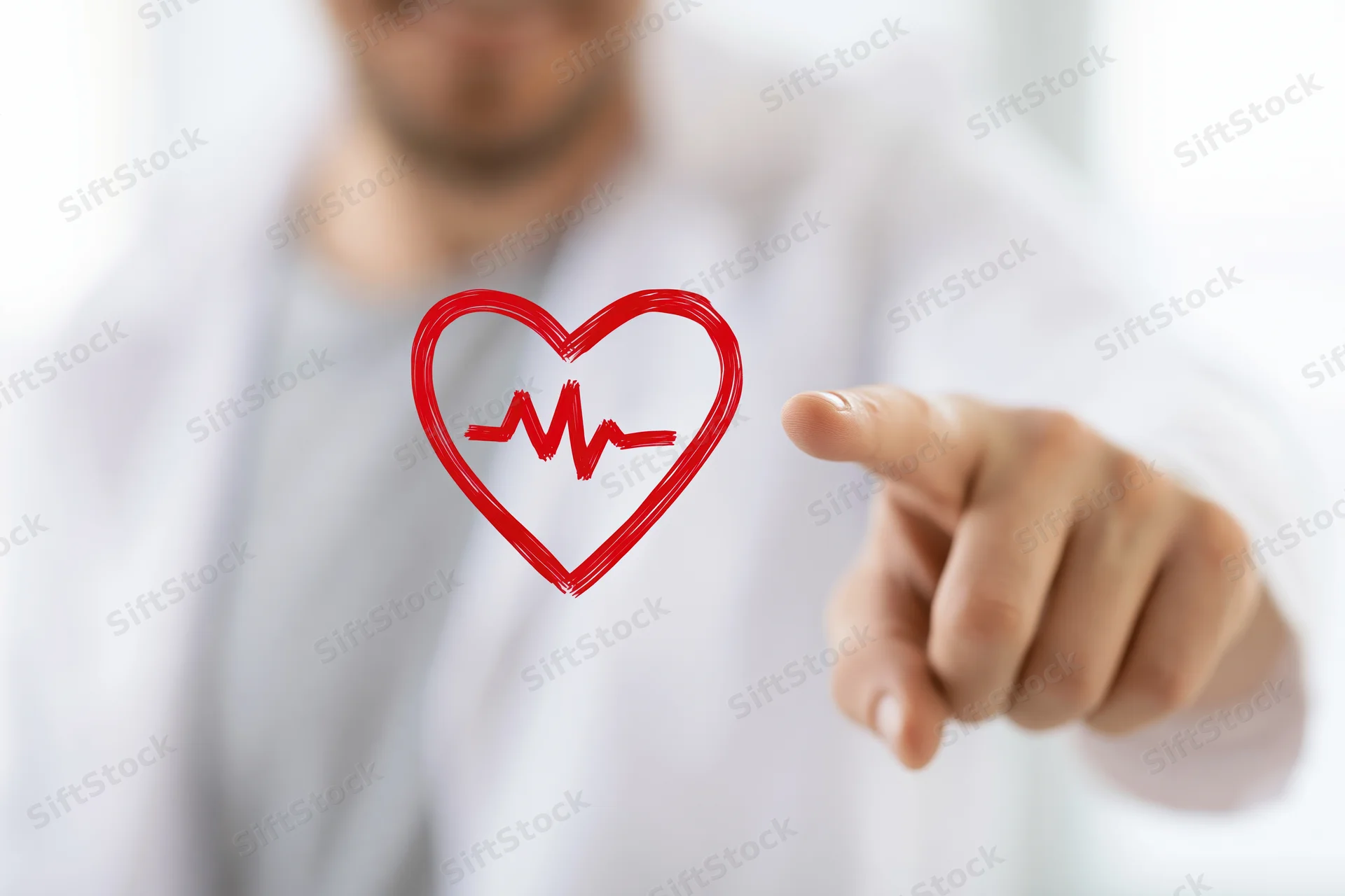 Doctor pointing at red heart symbol with heartbeat line on digital interface