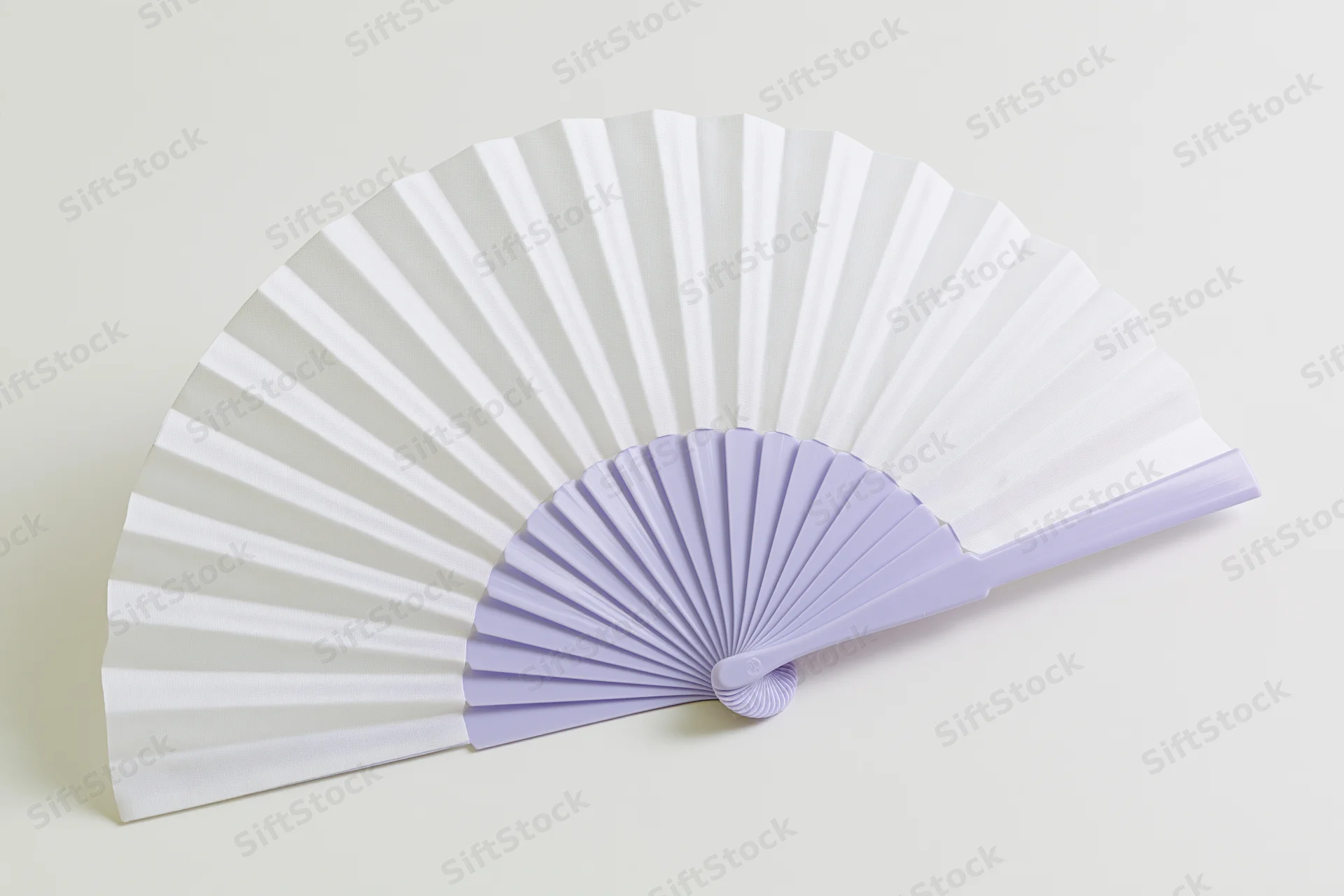 Open folding hand fan with white paper and lavender plastic frame lying flat on light beige surface