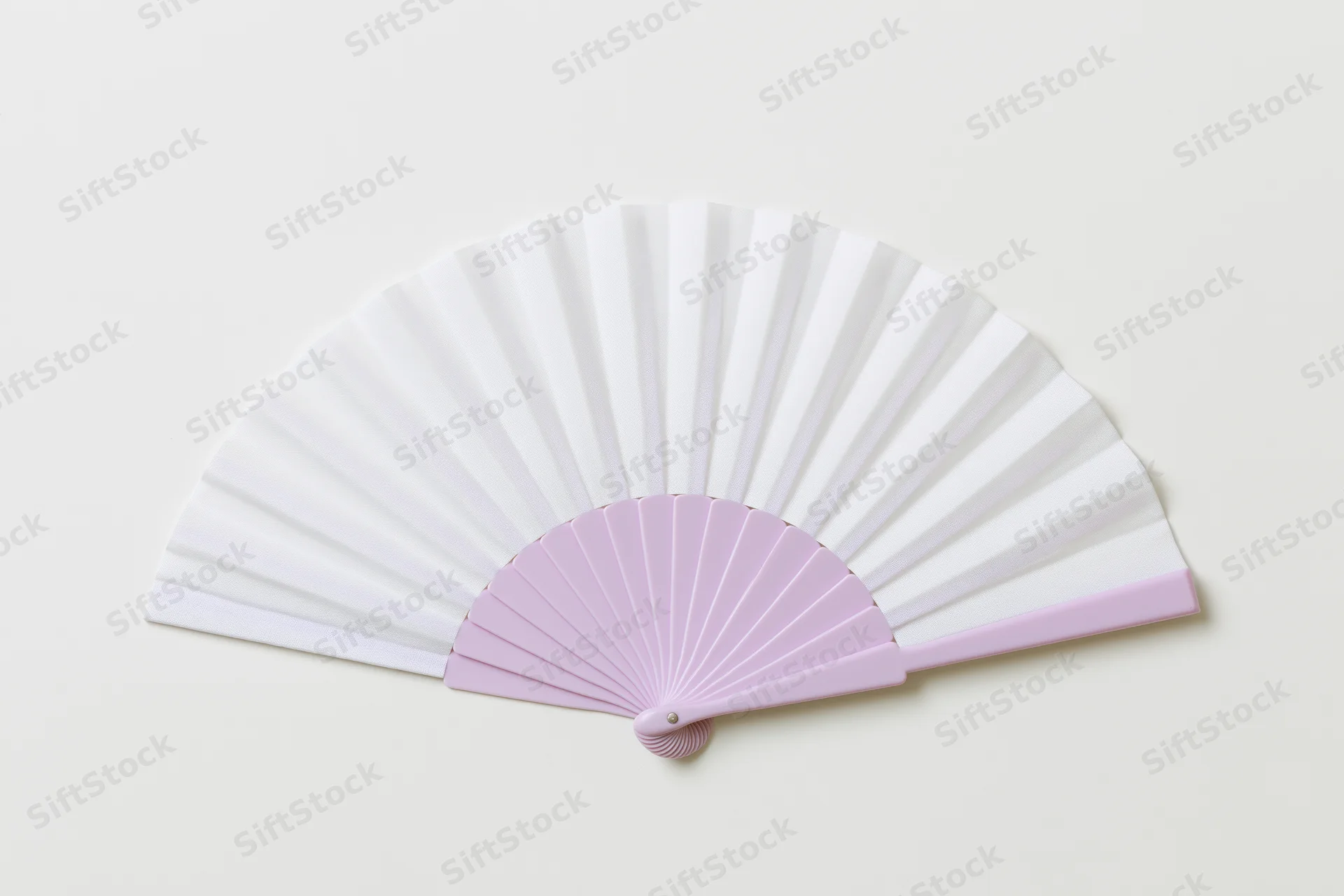 Open folding hand fan with white paper and pink plastic frame lying flat on cream background
