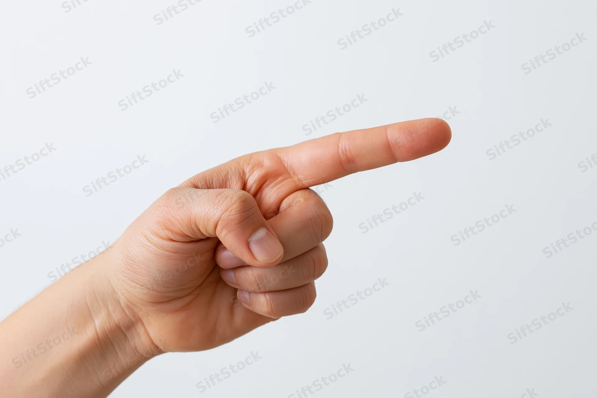 Hand with index finger extended pointing sideways against white background