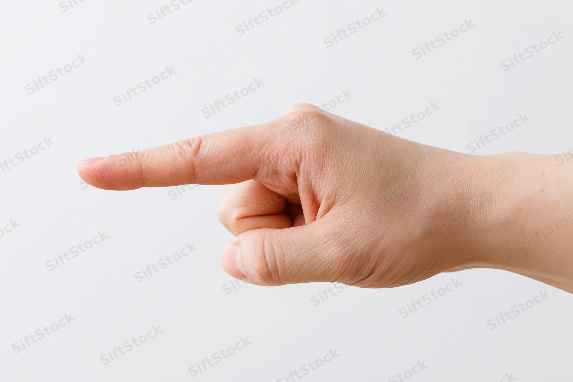 Hand with index finger pointing sideways against white background