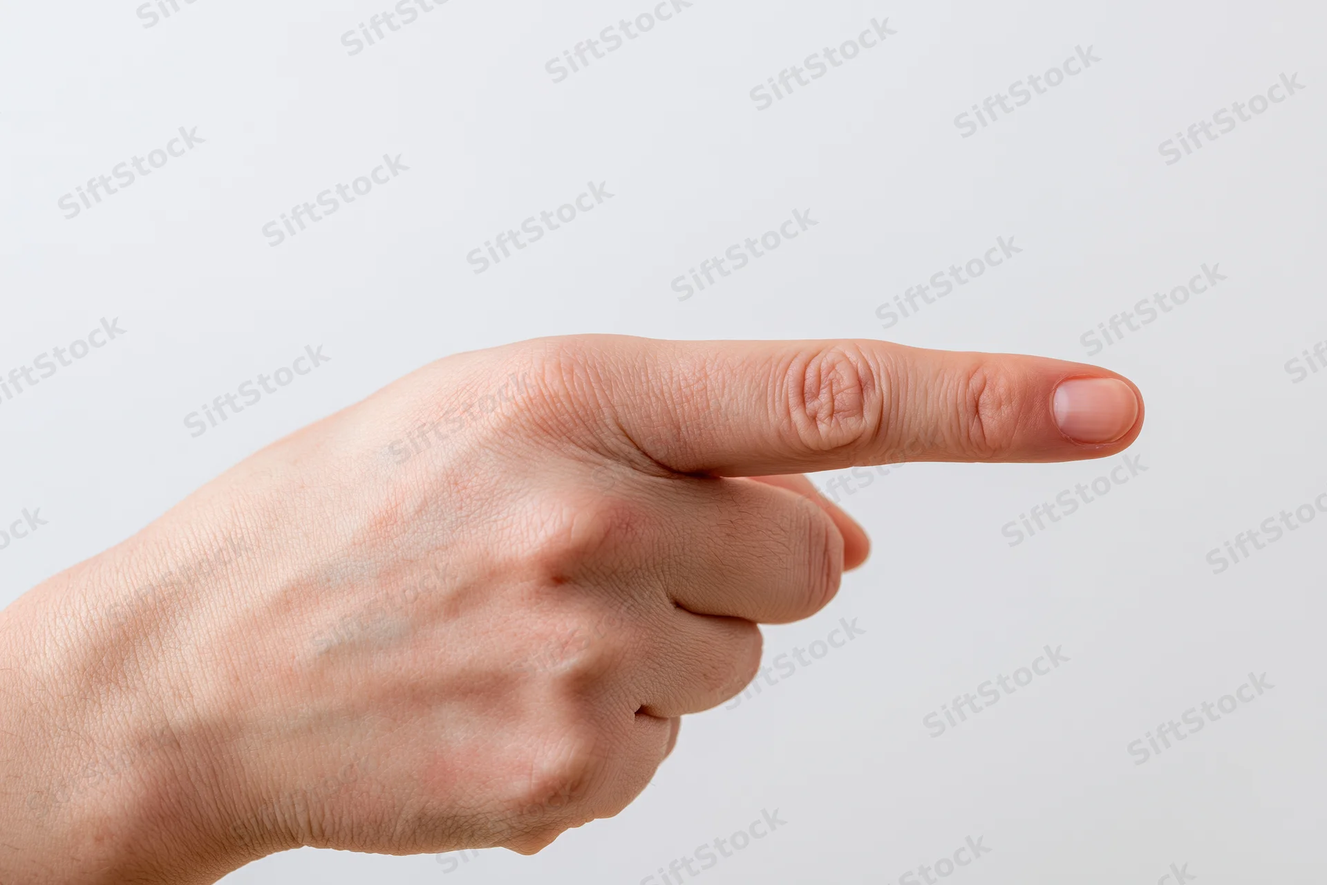 Hand with index finger pointing sideways against white background