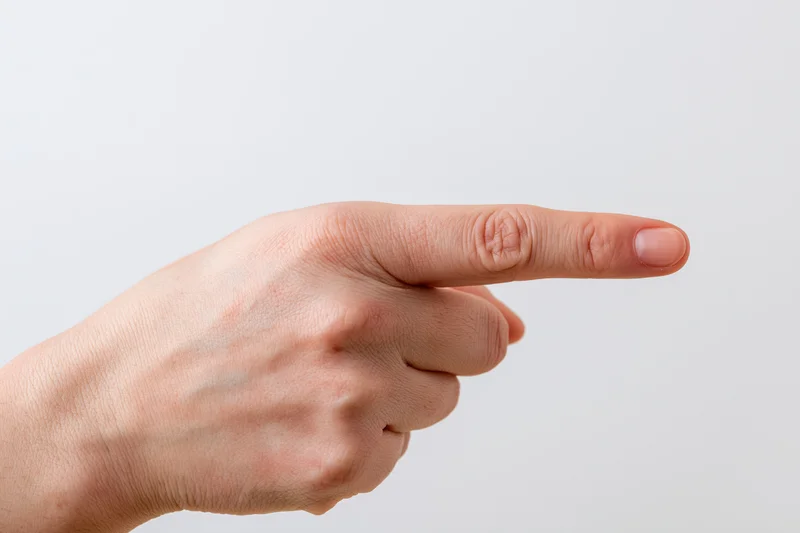 Hand with index finger pointing sideways against white background
