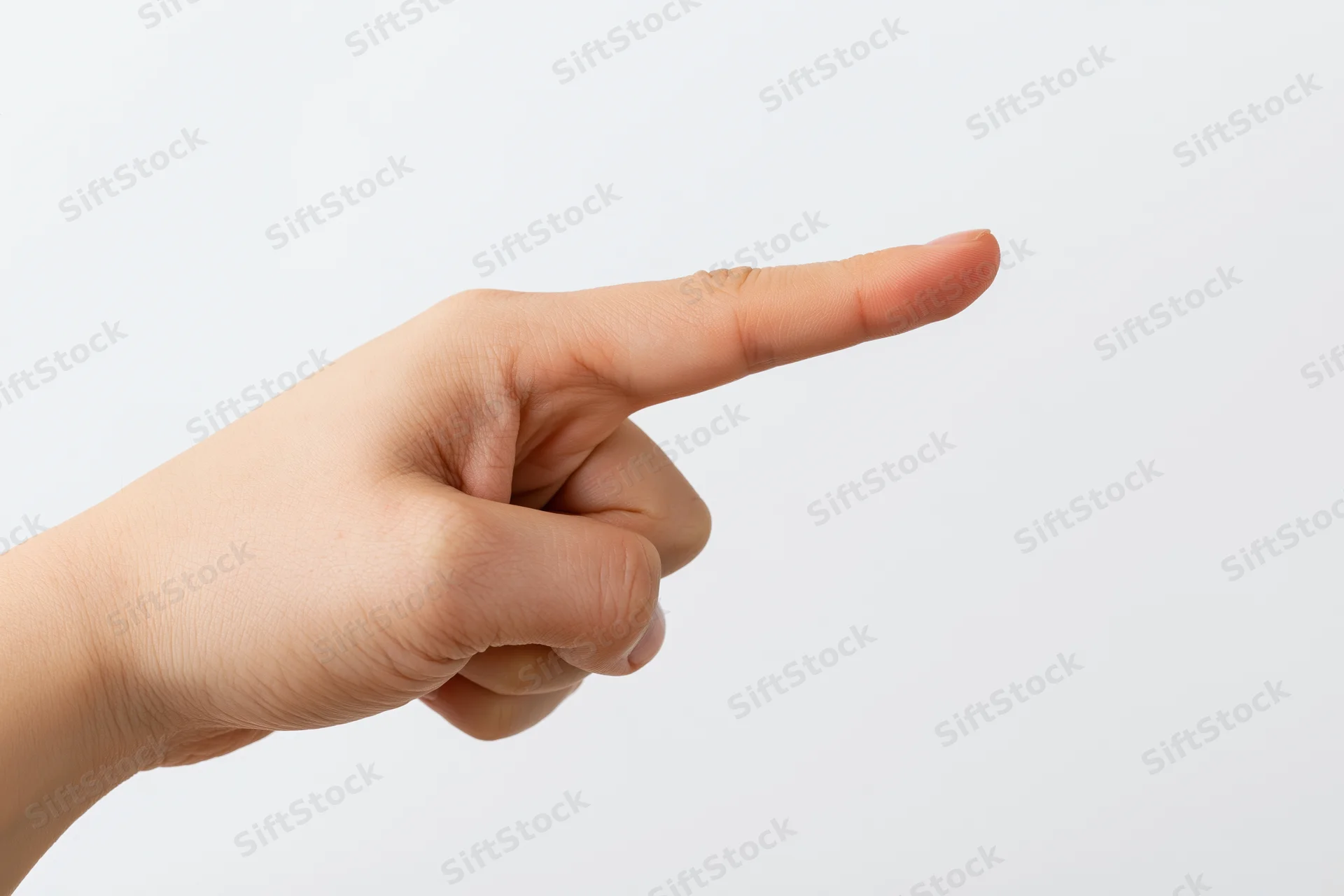Hand with index finger pointing sideways against white background