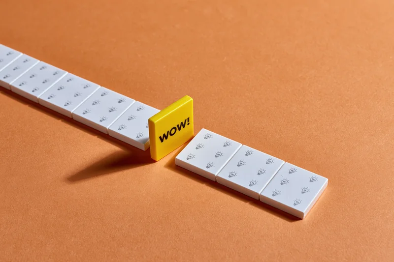 White tiles with lightbulb icons arranged in a row interrupted by a yellow tile with wow text on orange surface