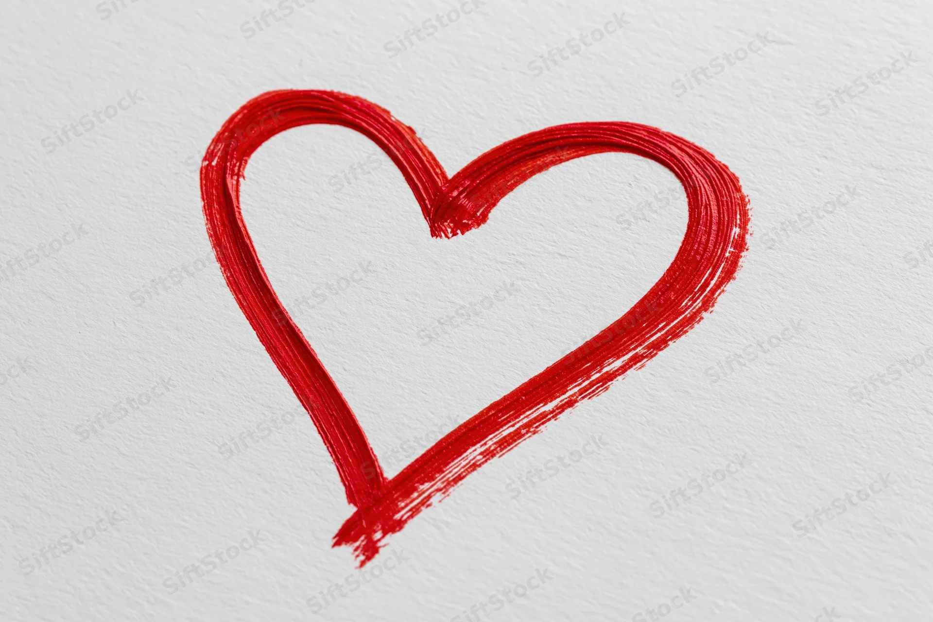 Red heart outline drawn with a single continuous brushstroke on textured white paper