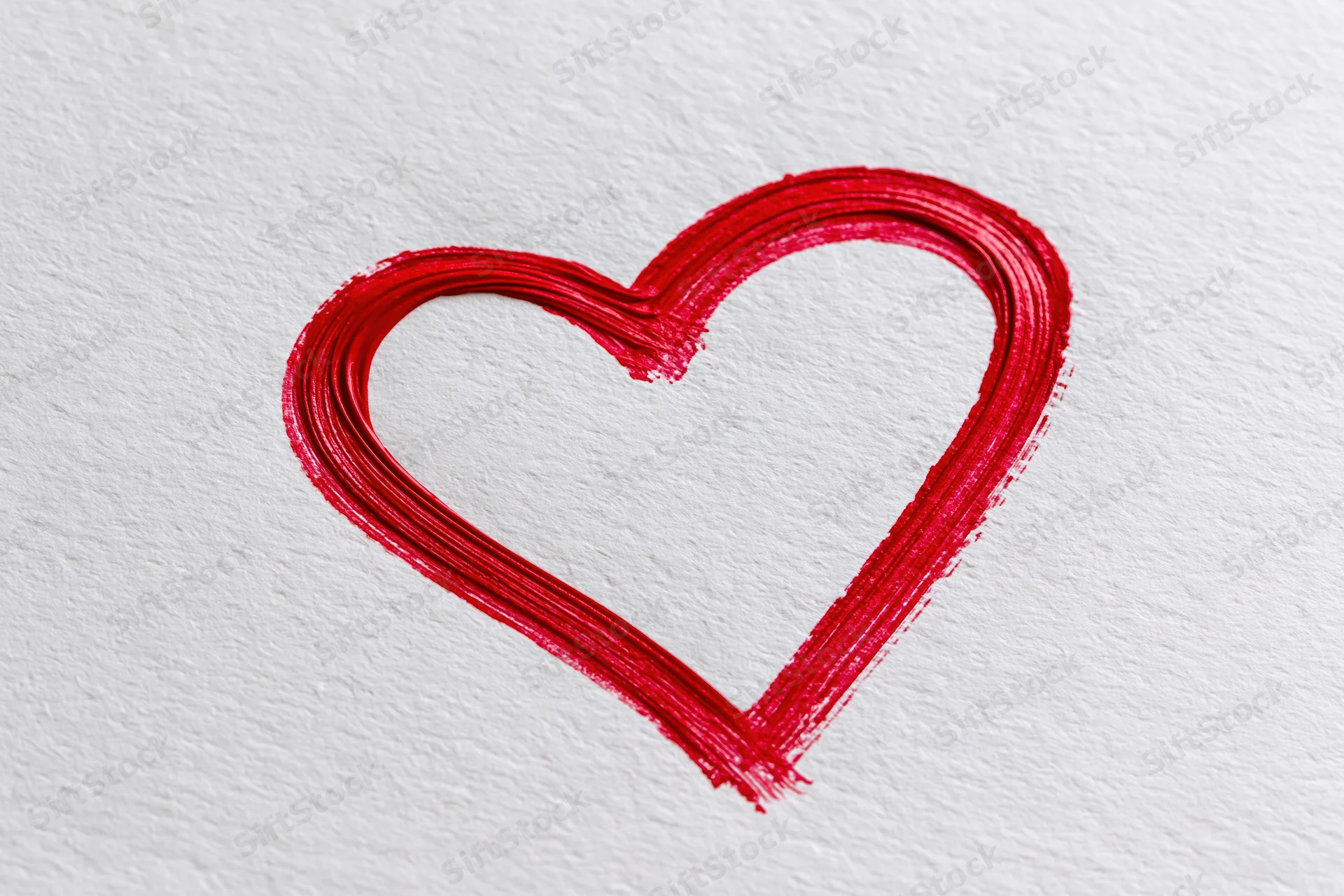 Red heart outline drawn with a single continuous brushstroke on textured white paper