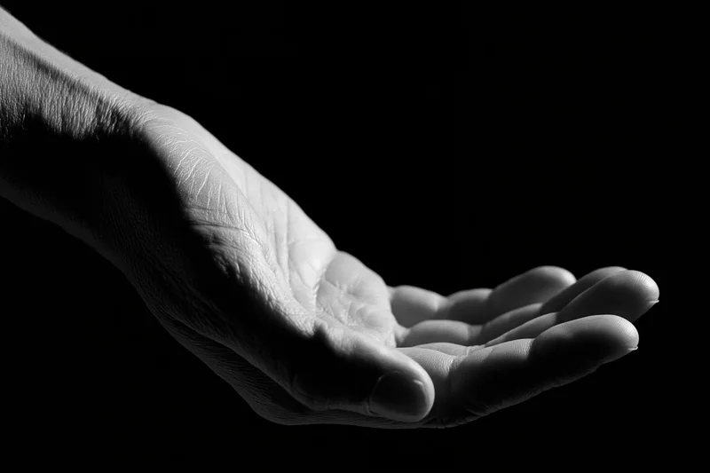 Open hand cupped upward against black background