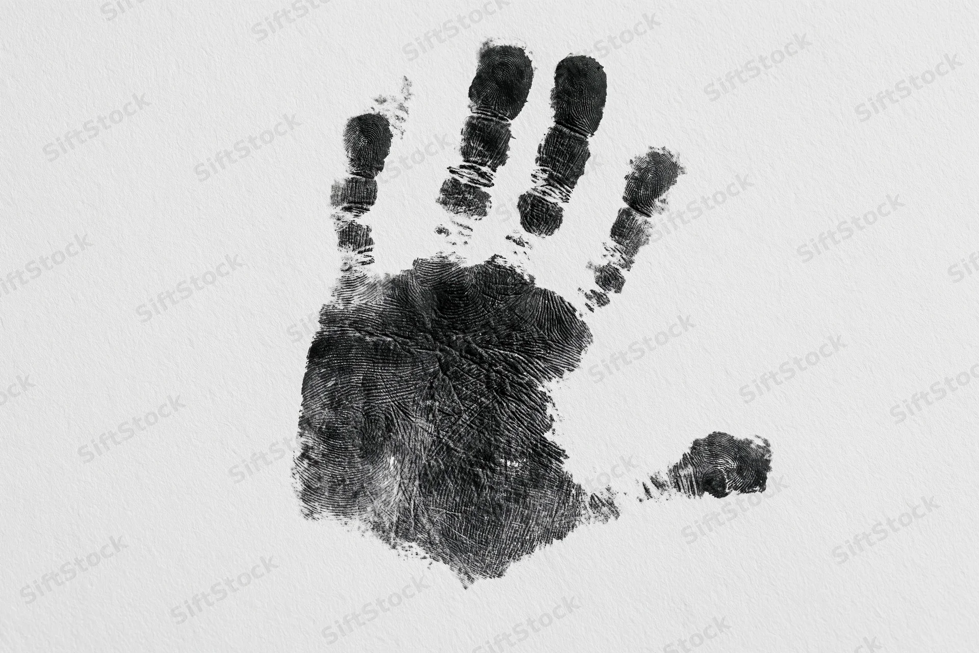 Black ink handprint of a child's hand on white paper