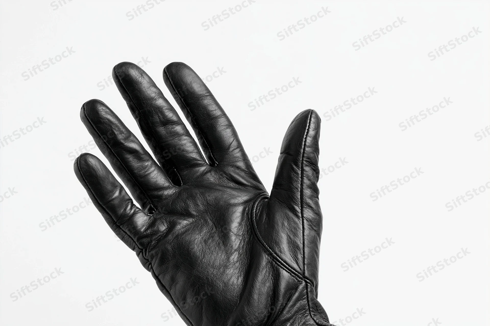 Black leather glove with fingers spread open against white background