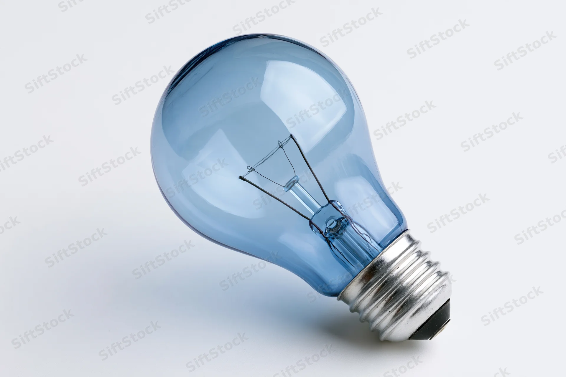 Blue-tinted incandescent light bulb with visible filament on white background