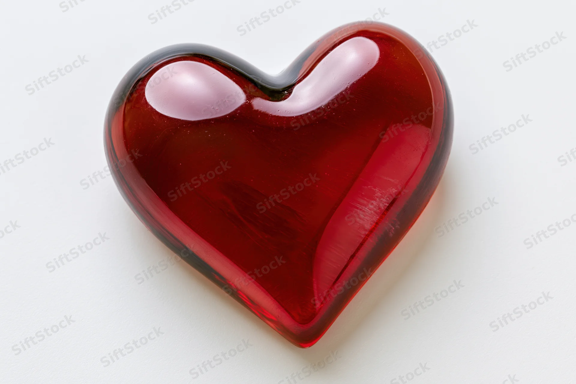 Glossy red heart ornament centered on white background