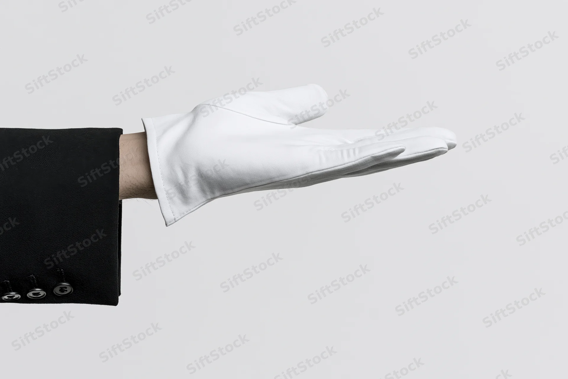 Gloved hand extended palm up in formal suit sleeve against white background