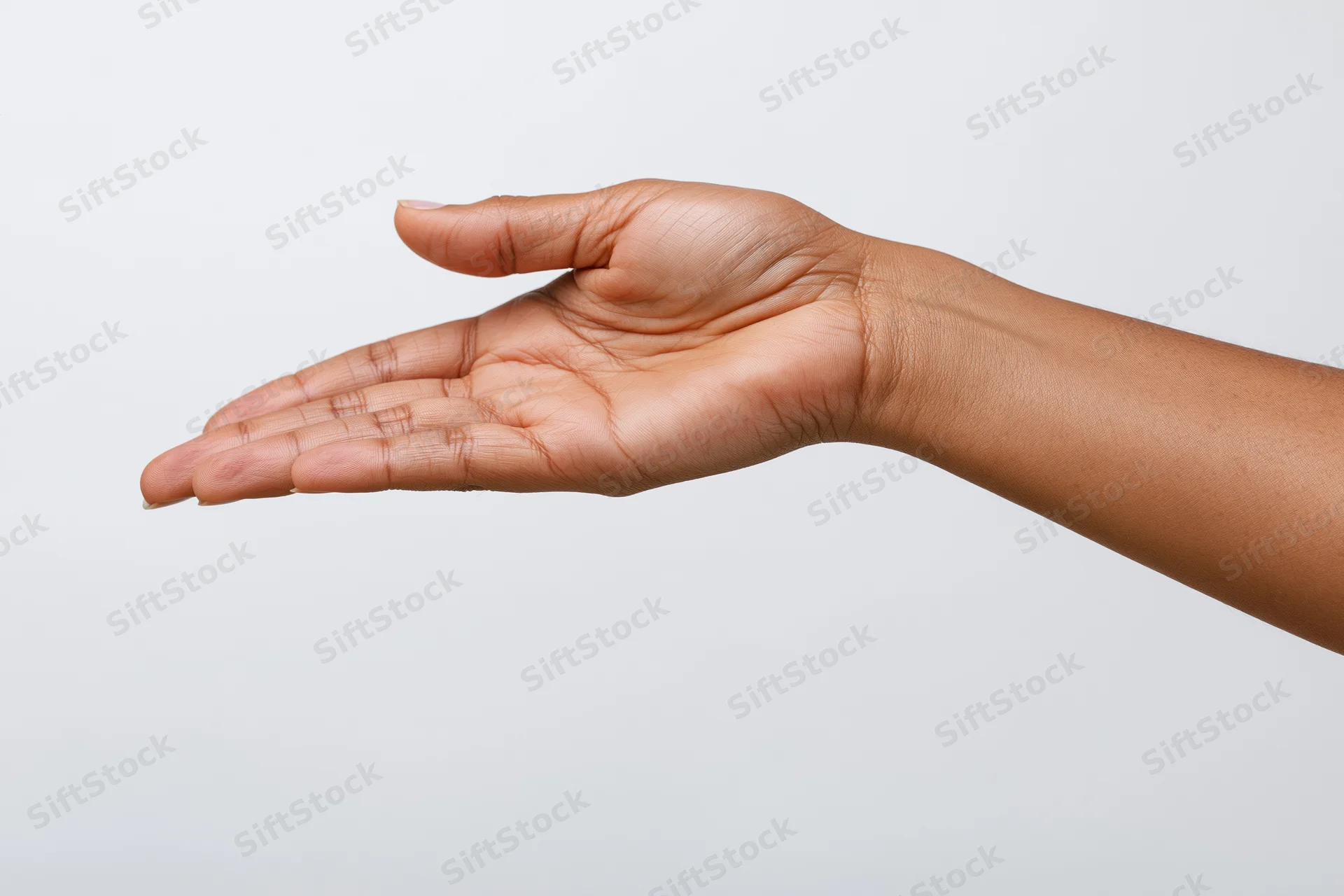 Open hand and forearm in relaxed gesture against white background with copyspace