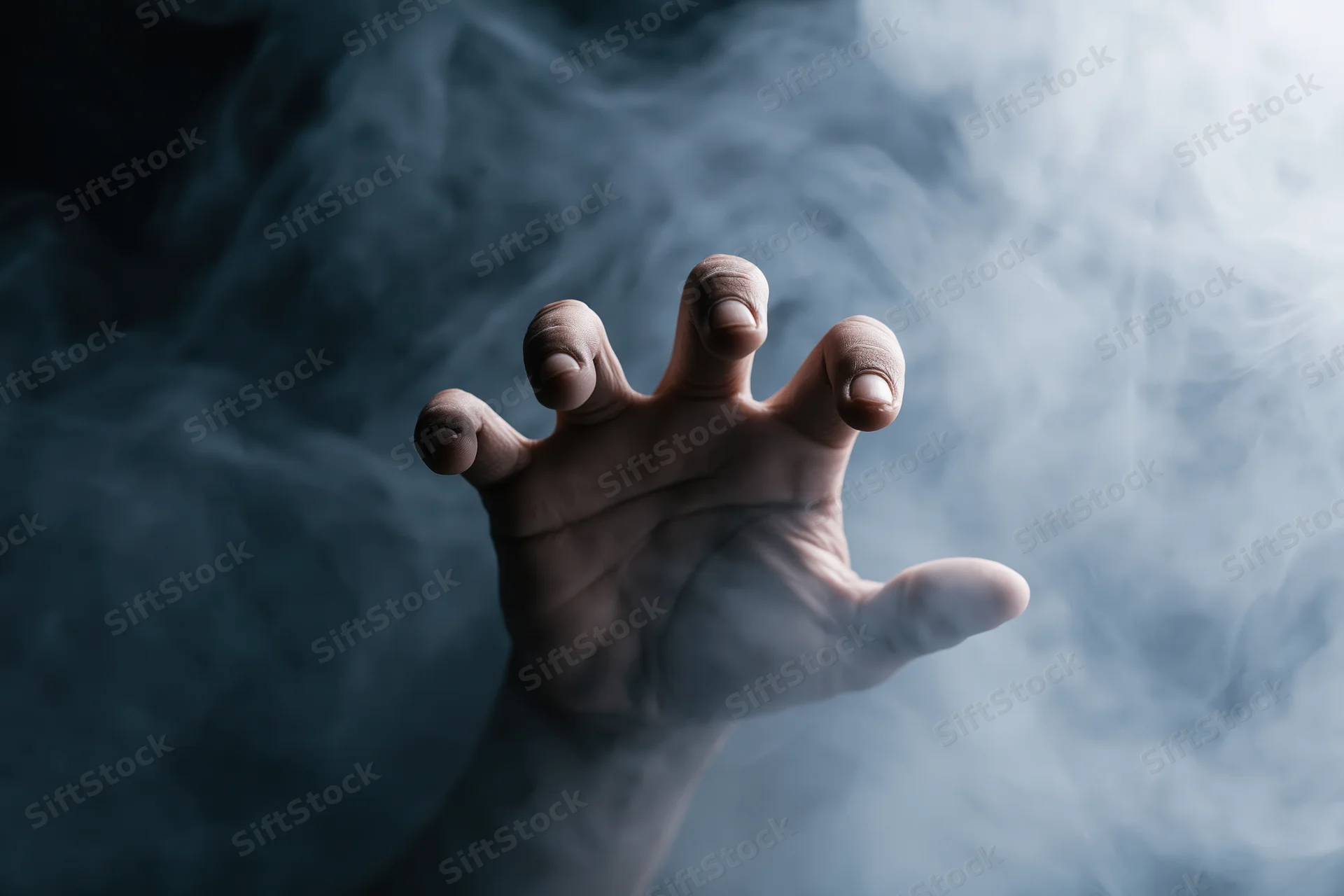 Hand reaching forward with fingers spread through swirling smoke
