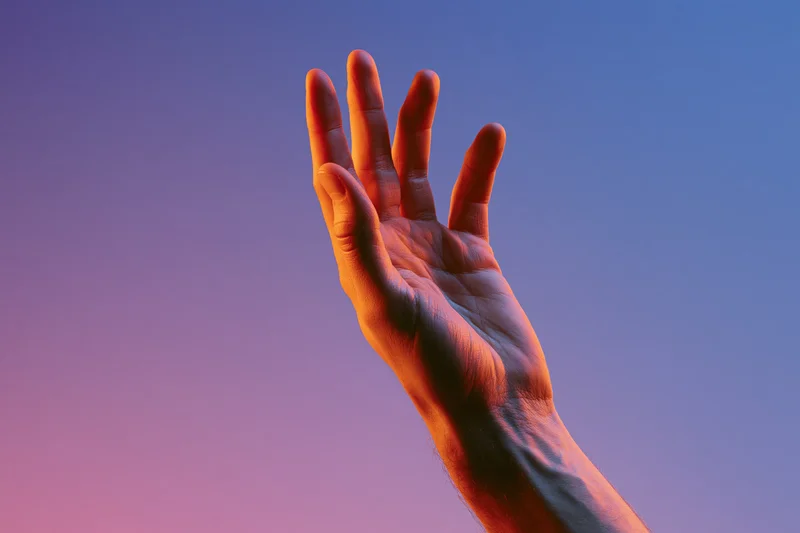 Hand reaching upward against a twilight sky gradient