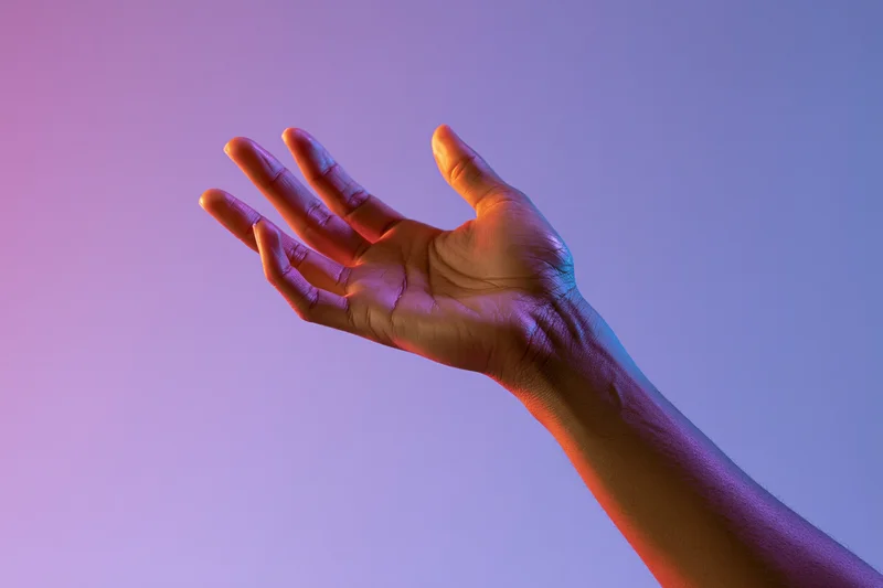 Hand reaching upward with fingers spread against a pink and purple gradient background