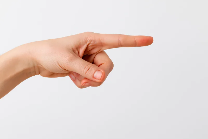 Hand with index finger extended pointing to the side on white background