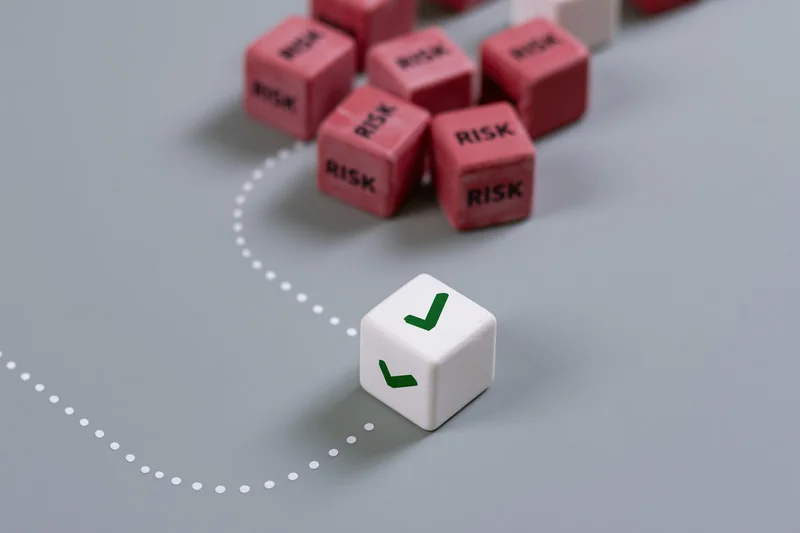 White cube with green checkmark navigating a dotted path away from red risk cubes on gray surface