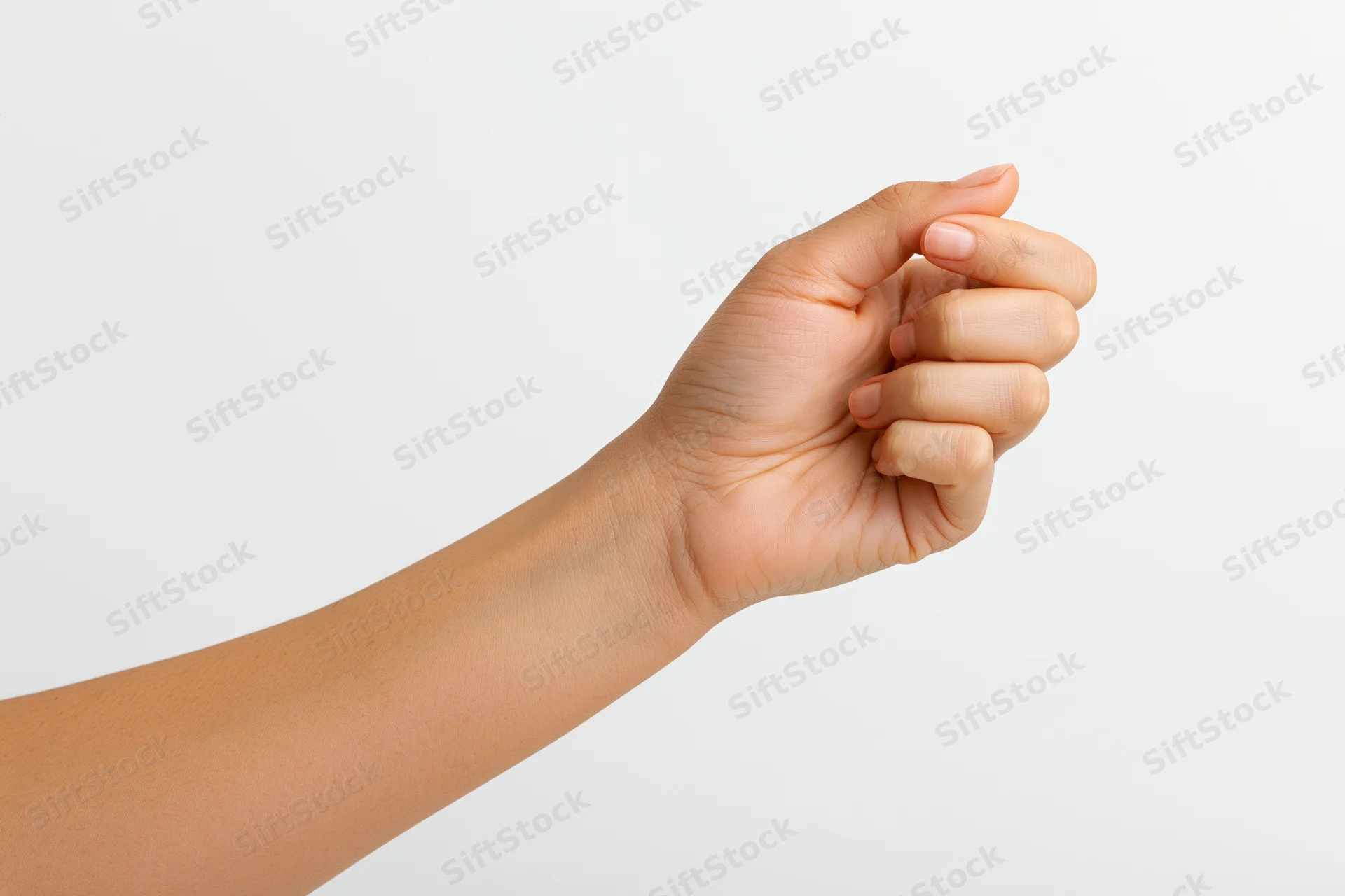 Woman's hand making pinch gesture against white background