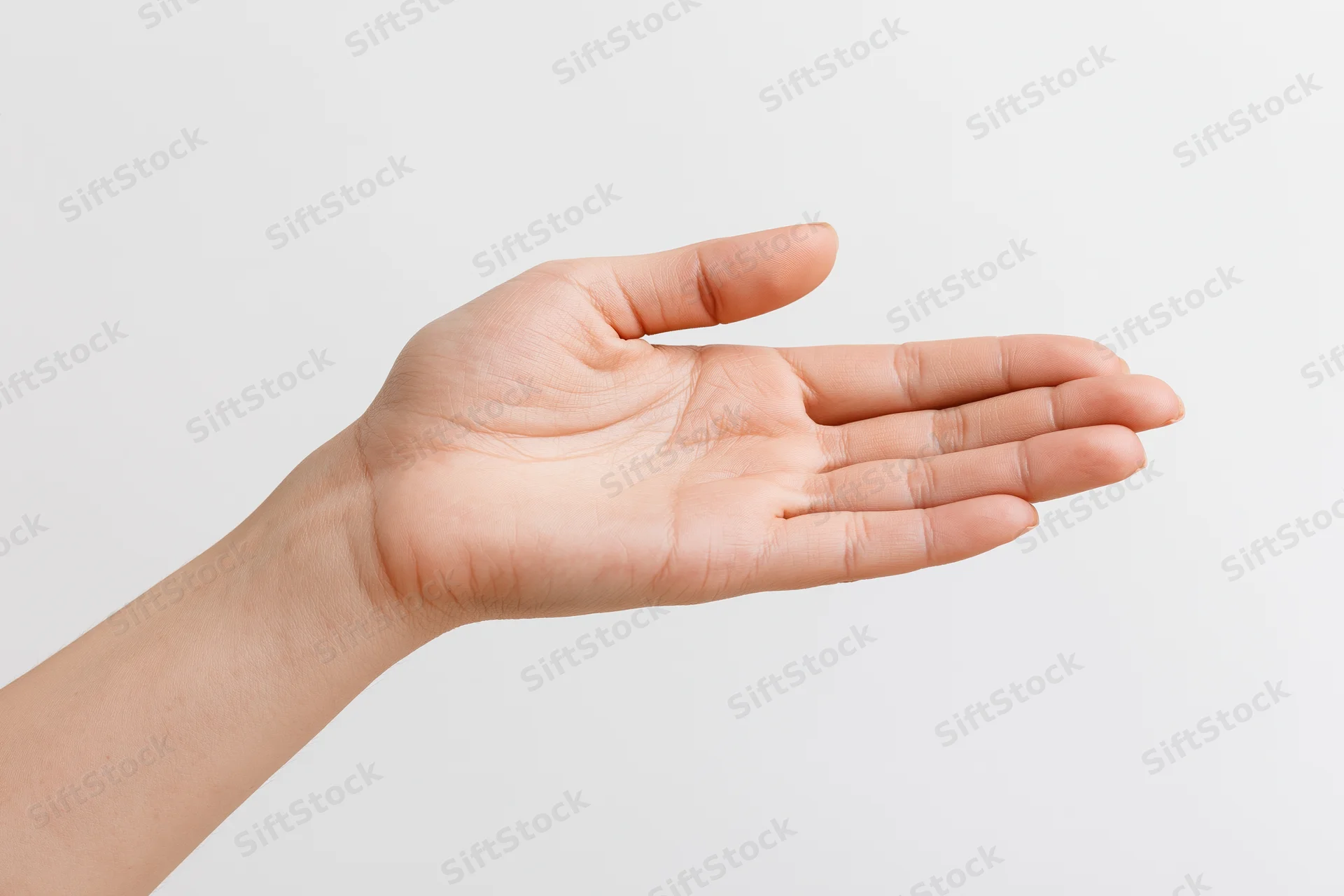 Woman’s hand with open palm extended against white background