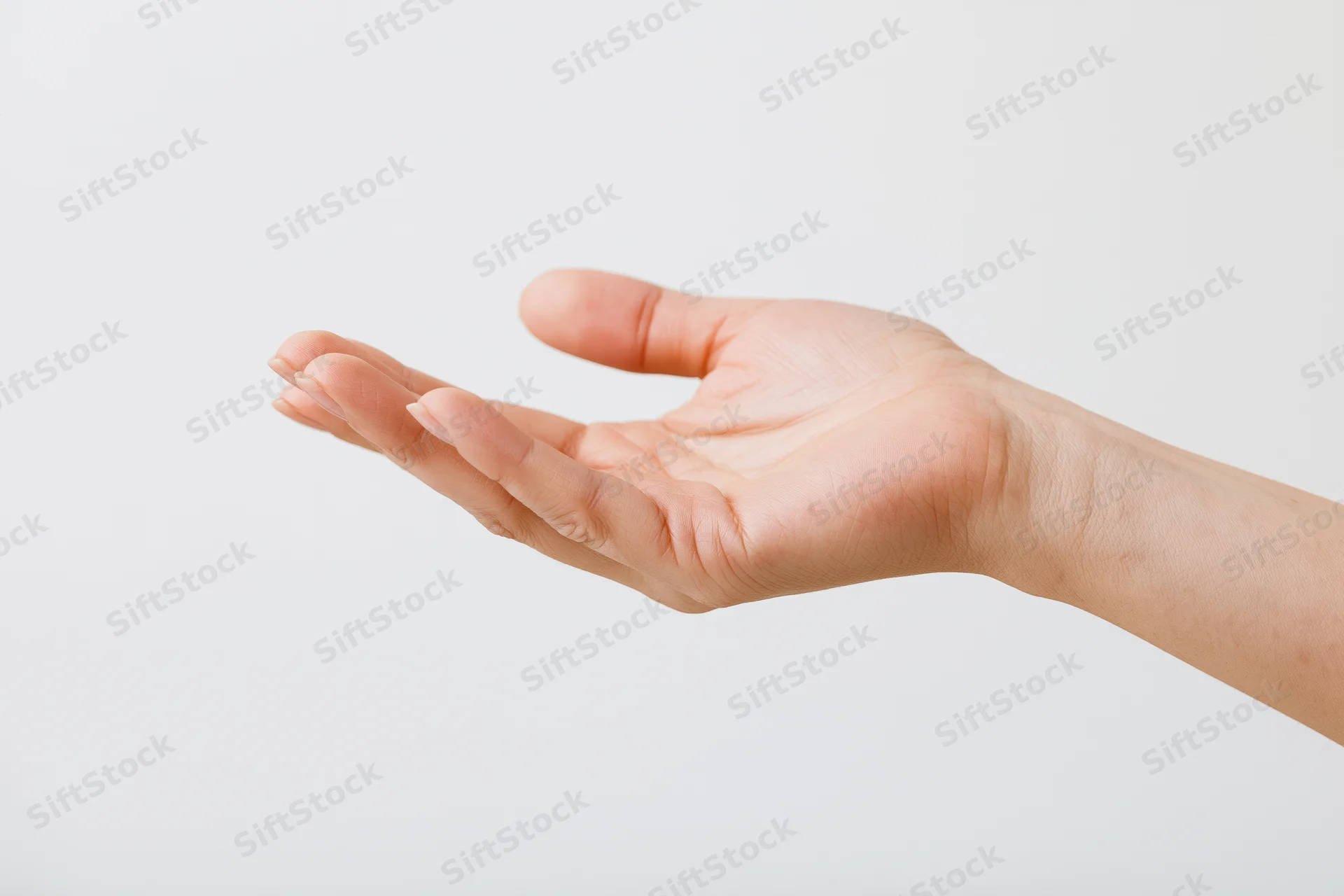 Woman's hand in open palm gesture against white background