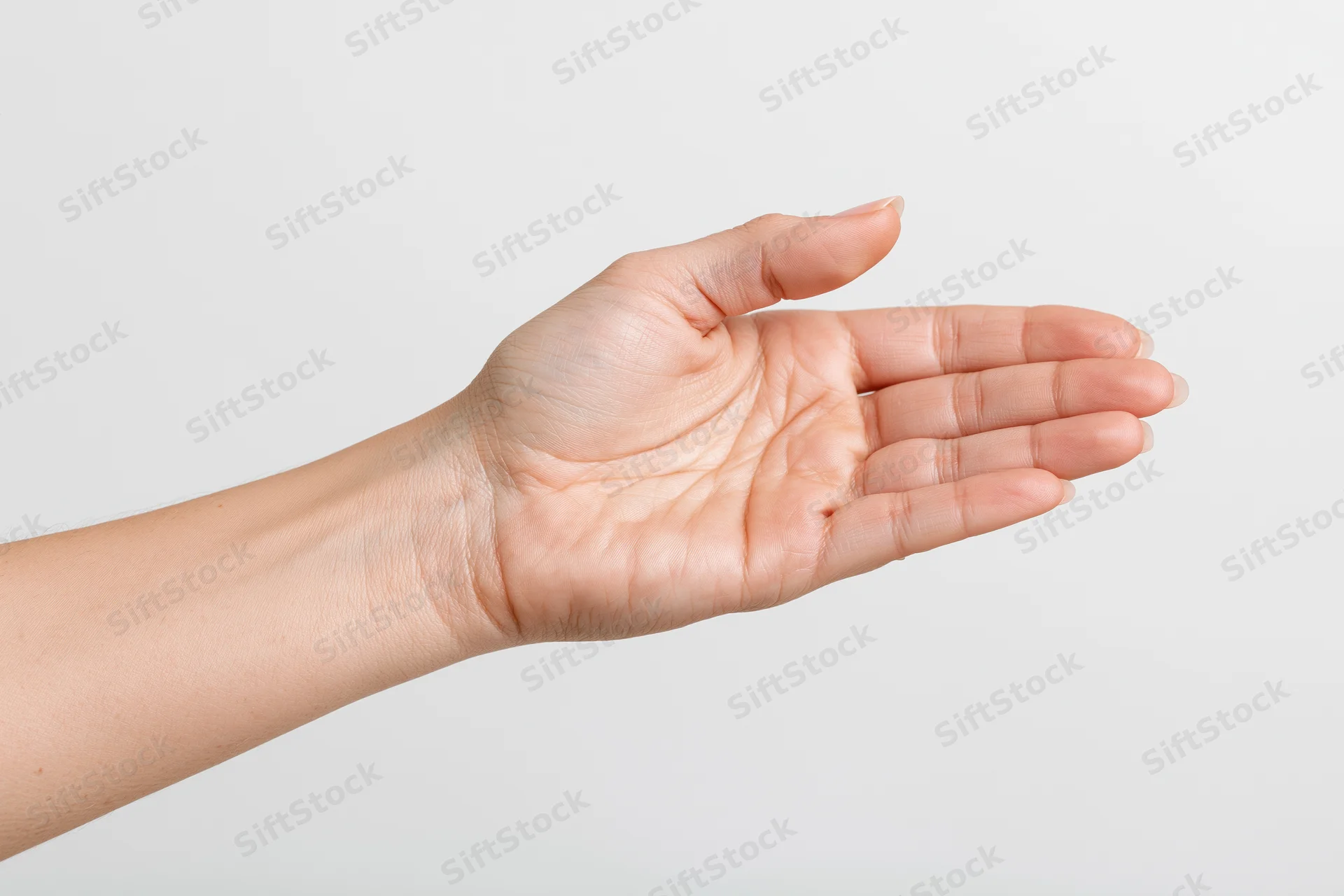 Woman's hand with open palm extended against white background