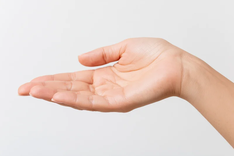 Woman's hand in open palm gesture against white background