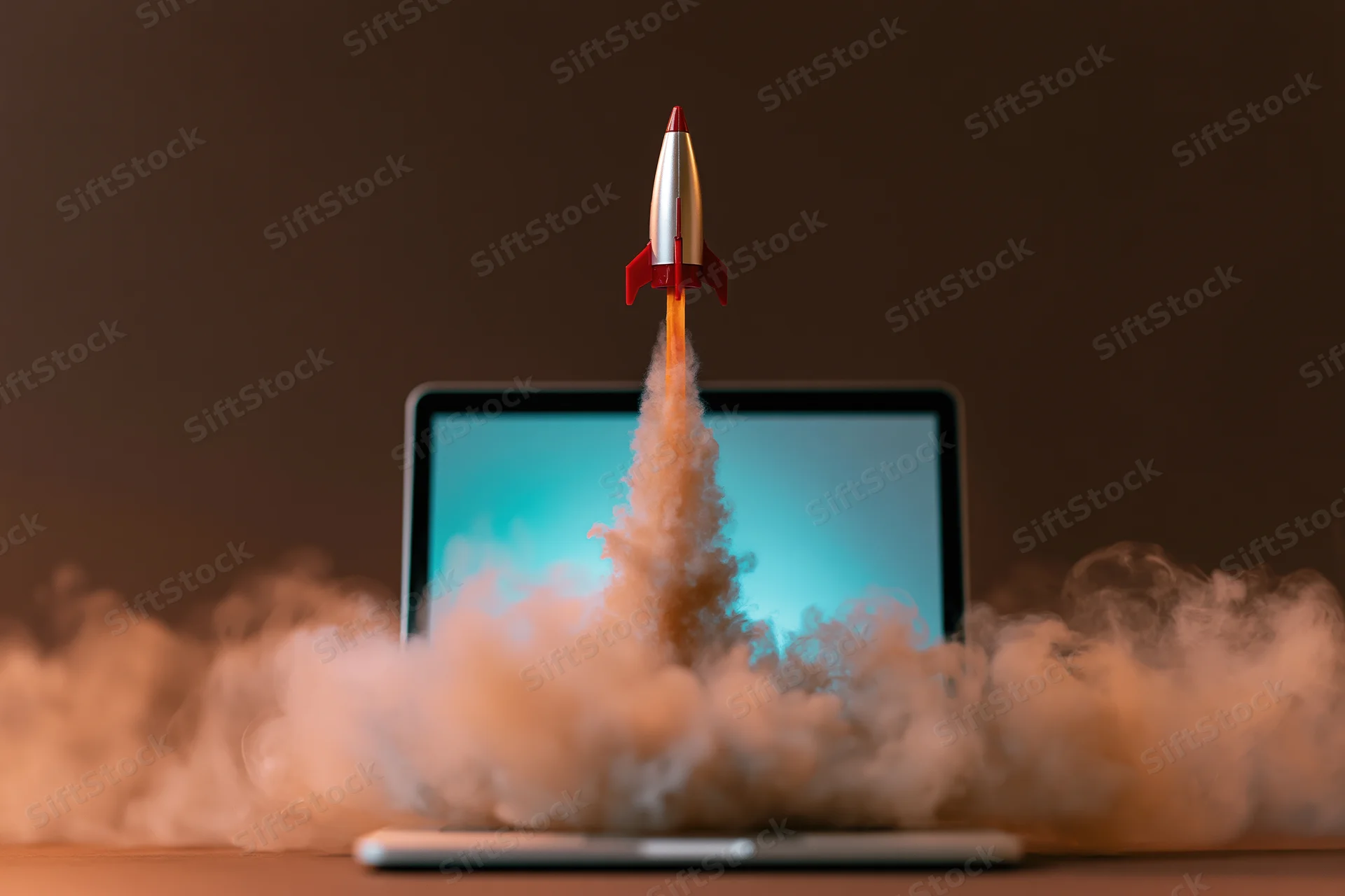 Toy rocket launching from laptop screen surrounded by smoke