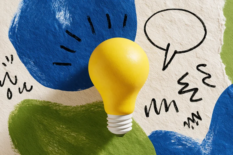 Yellow lightbulb centered on textured paper with hand-drawn sketches and abstract blue and green shapes