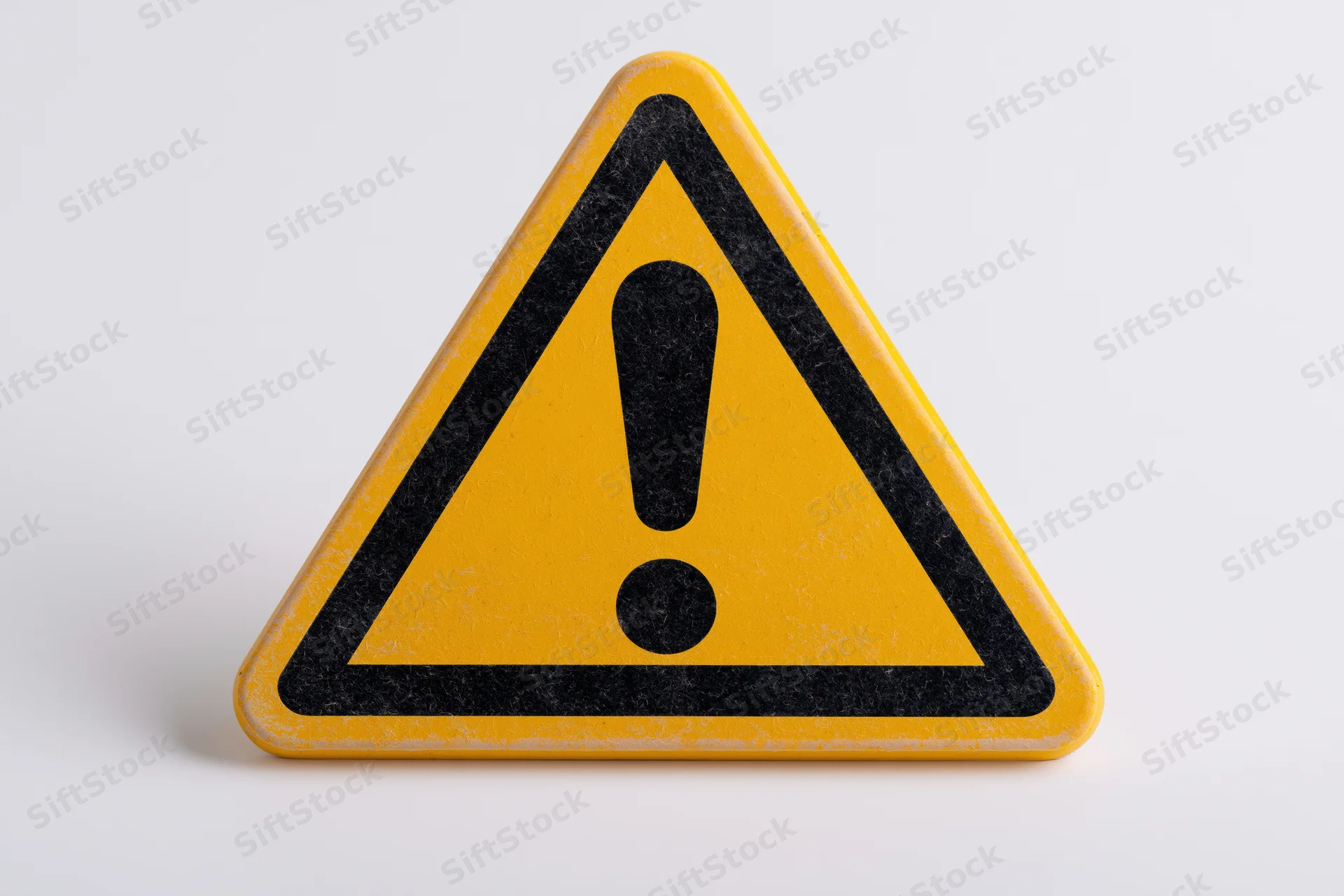 Yellow triangular warning sign with black exclamation mark on white background