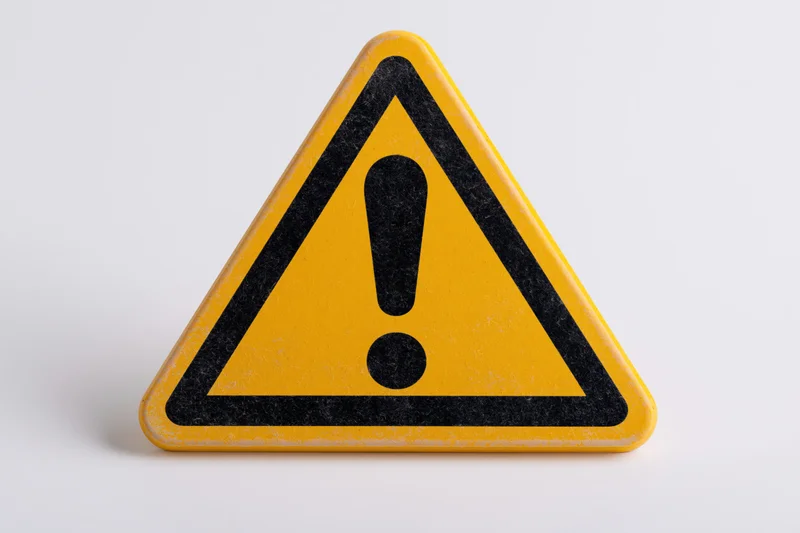 Yellow triangular warning sign with black exclamation mark on white background