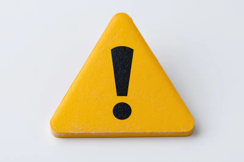 Yellow triangular warning sign with black exclamation mark on white background