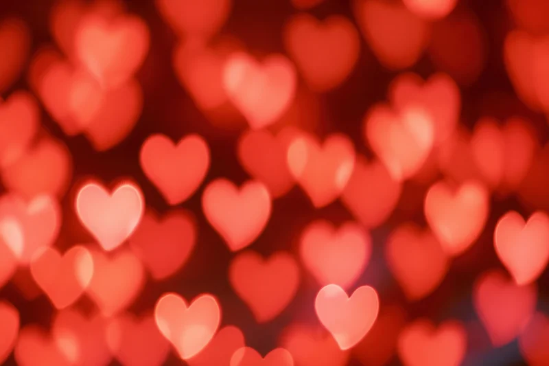 Soft out-of-focus heart-shaped lights forming a romantic bokeh background