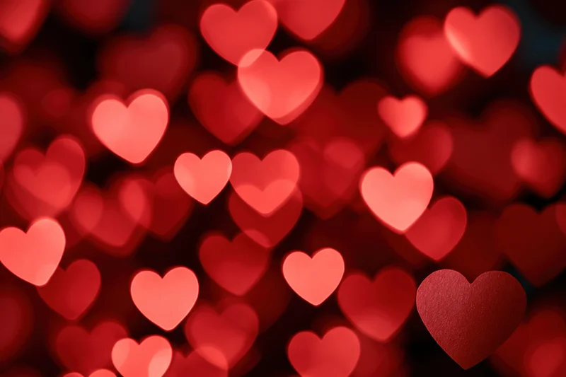 Soft red heart bokeh lights forming a romantic background