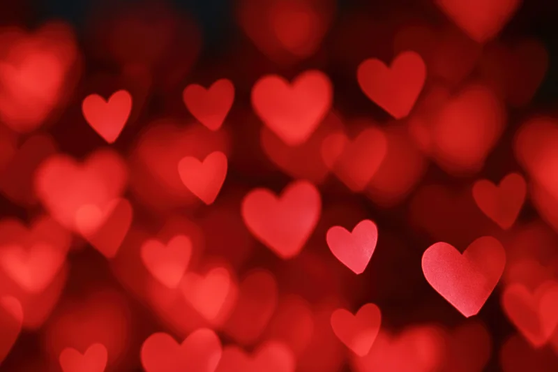 Soft red heart-shaped bokeh lights filling the frame as a romantic background
