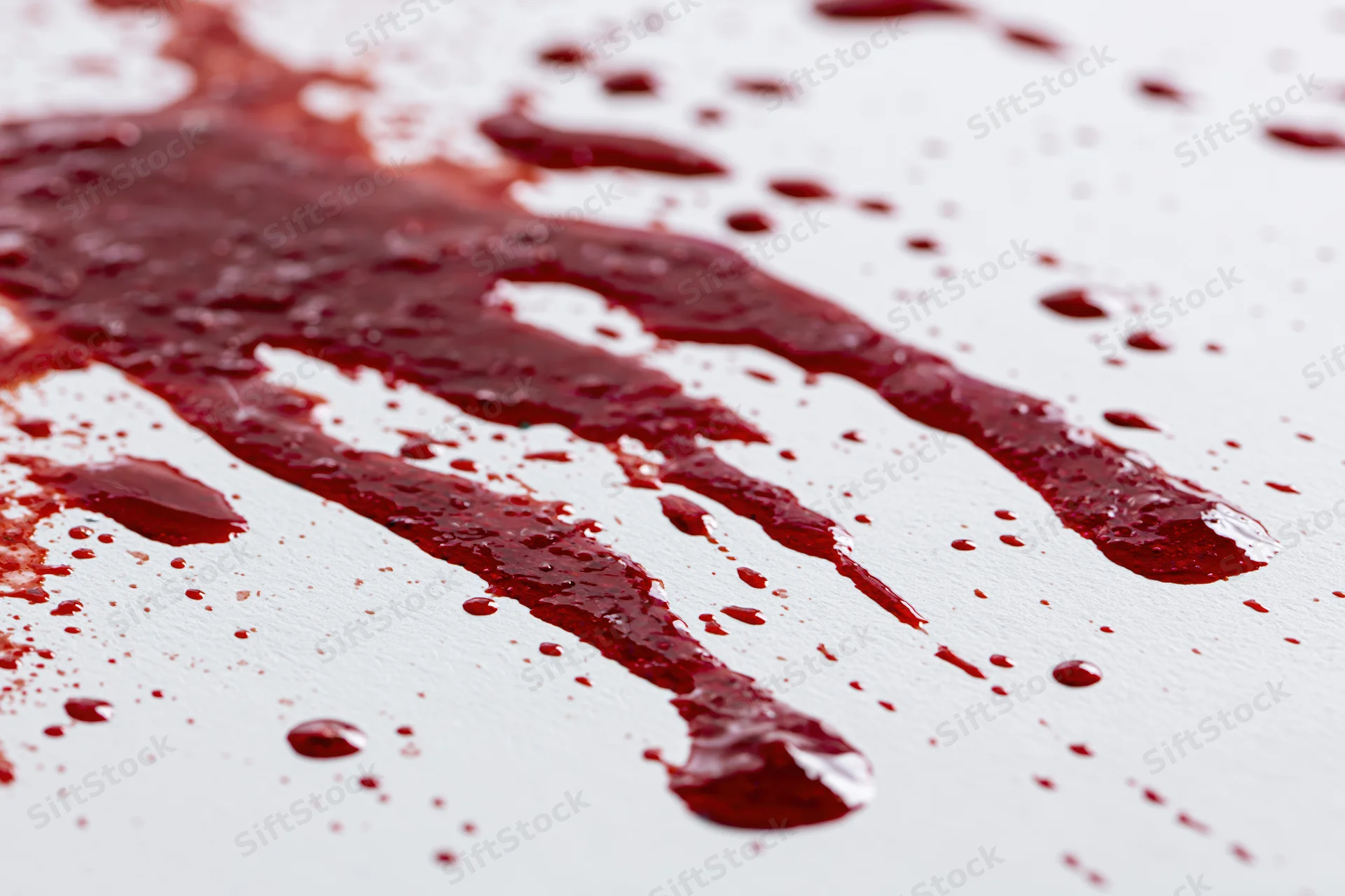 Blood splatter and drip marks on a white surface