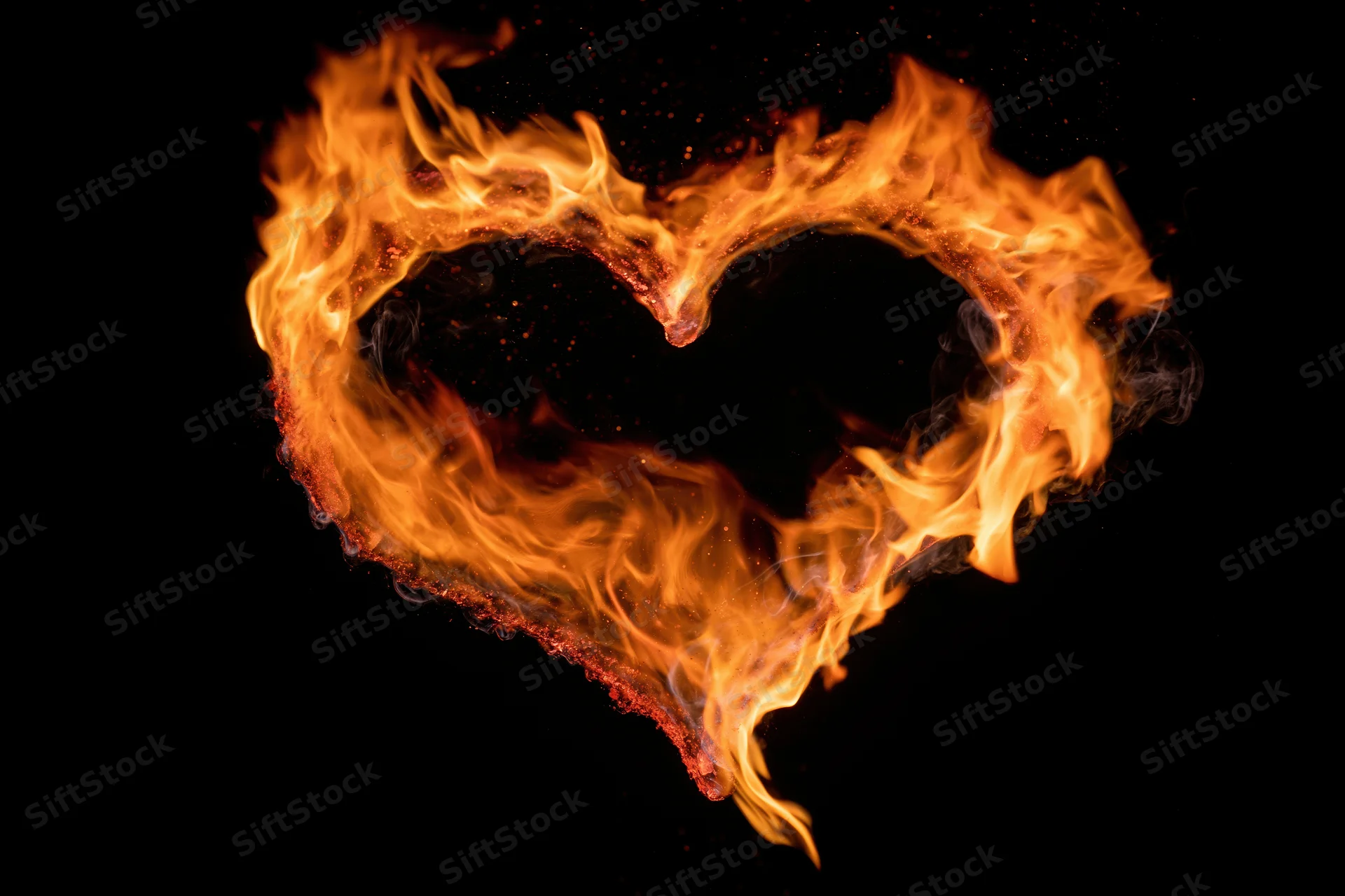 Heart-shaped flames burning against a black background