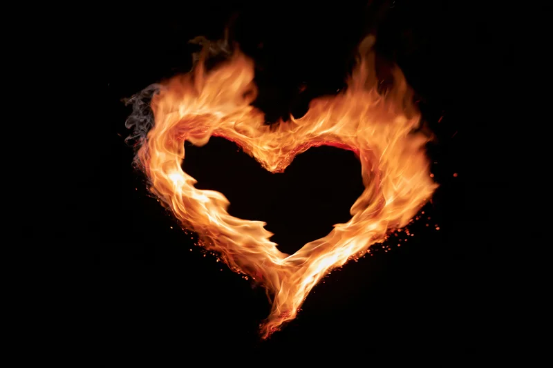 Heart-shaped flames burning against a black background