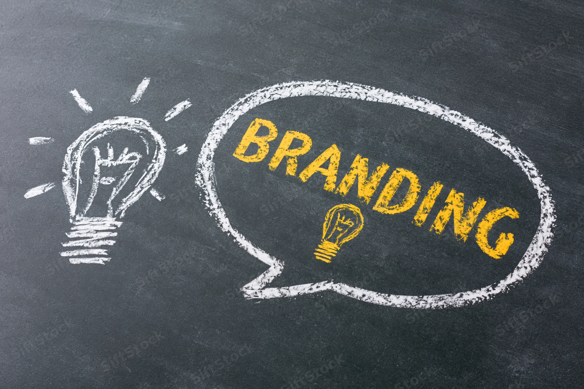 Chalk drawing of a lightbulb and speech bubble with the word branding on a blackboard
