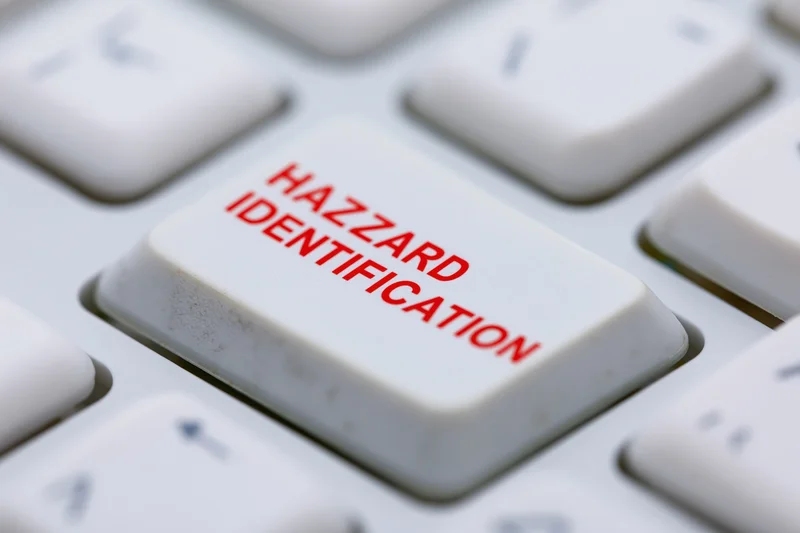 Close-up of a white keyboard key labeled hazard identification in red text