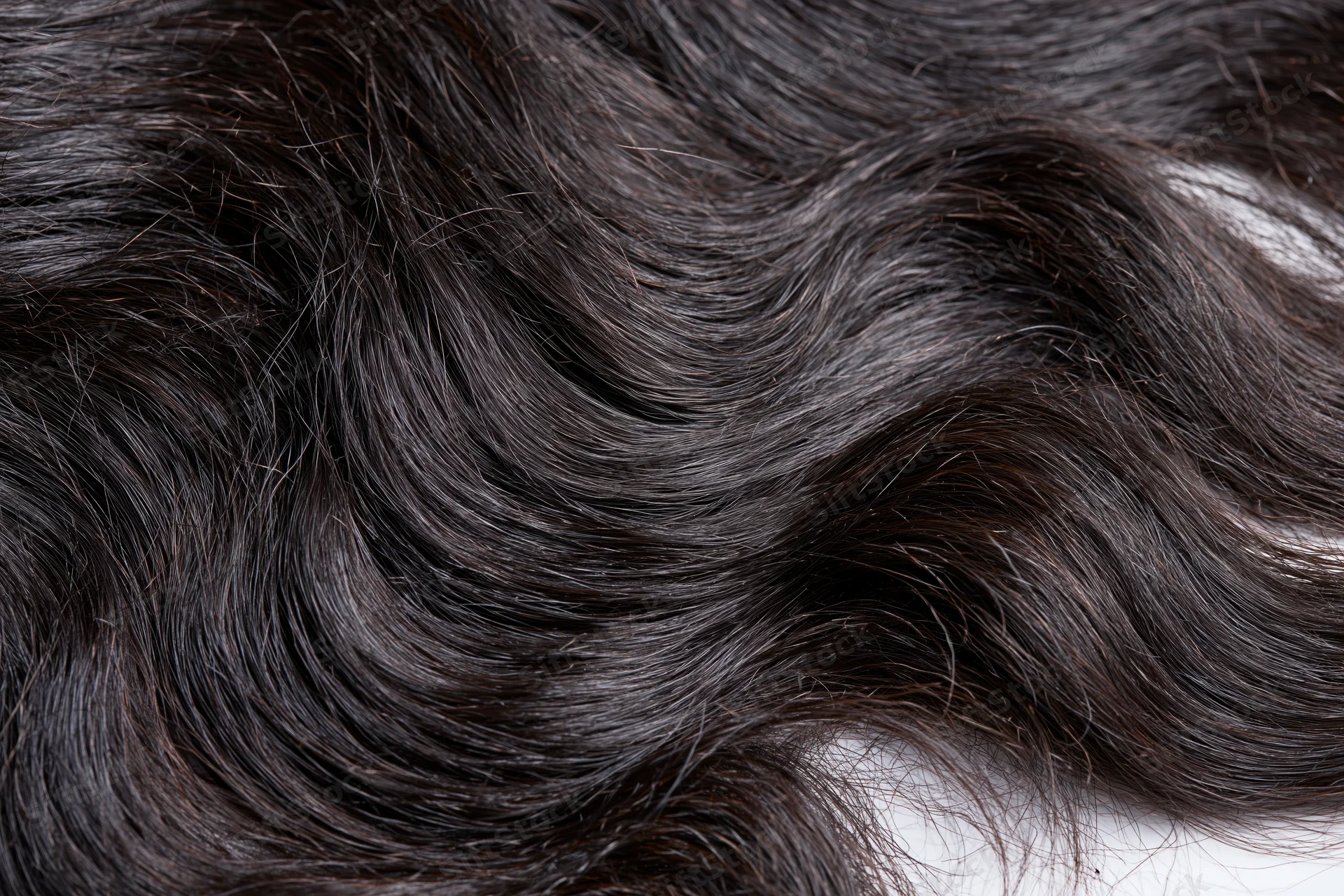 Close-up of dark wavy human hair extensions showing texture and shine