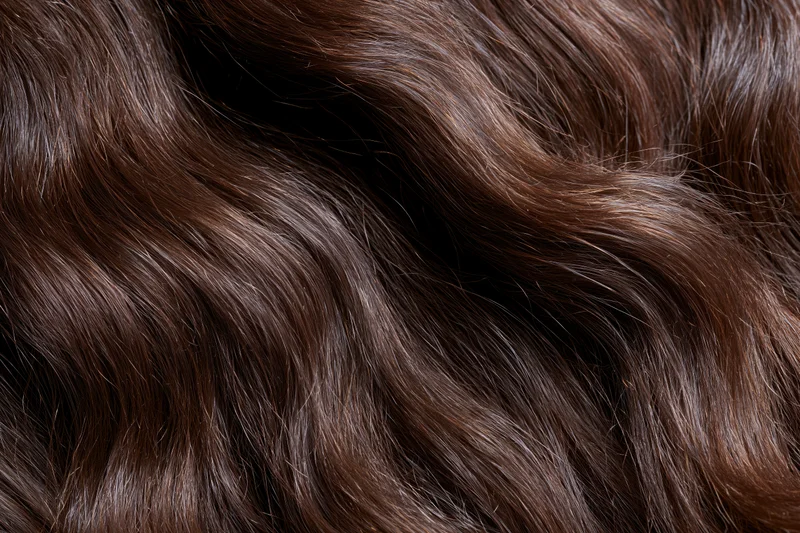 Close-up of dark brown wavy hair filling the frame