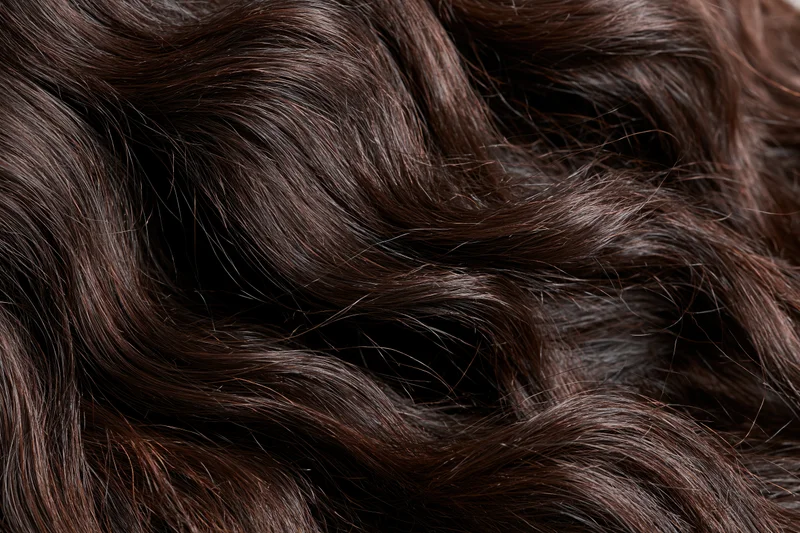 Close-up of dark brown wavy hair filling the frame