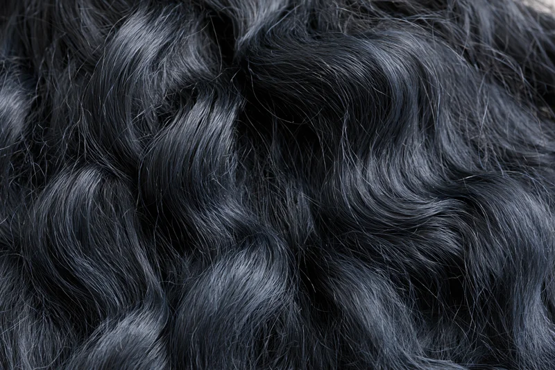Close-up of thick wavy black hair filling the frame