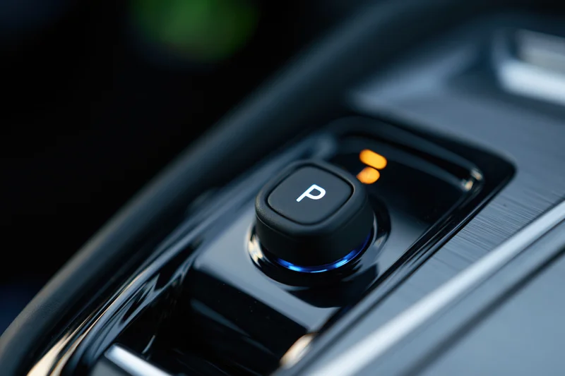 Close-up of electronic gear selector button in modern car console