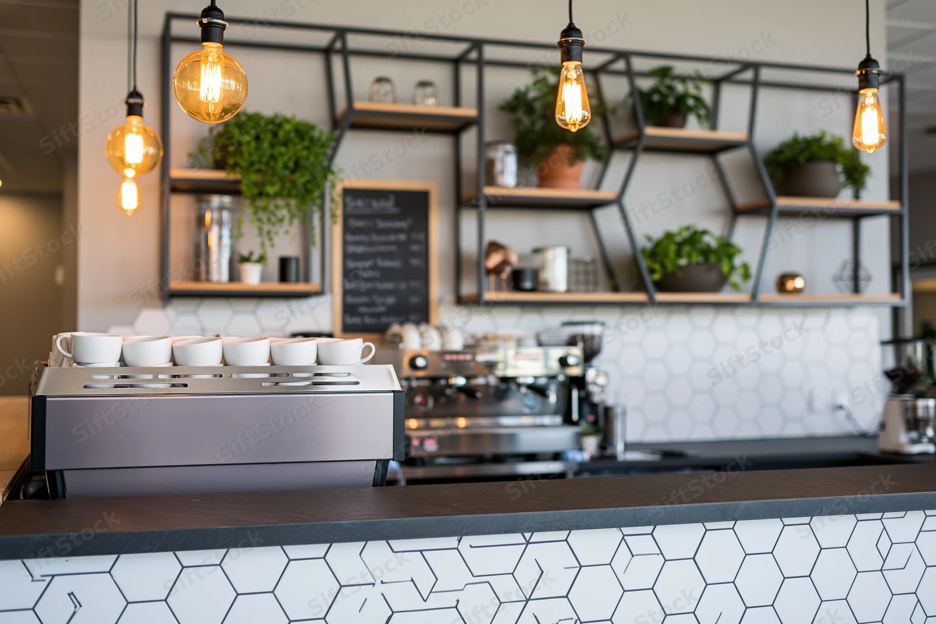 Coffee shop bar counter with commercial espresso machine and hexagonal tile backsplash