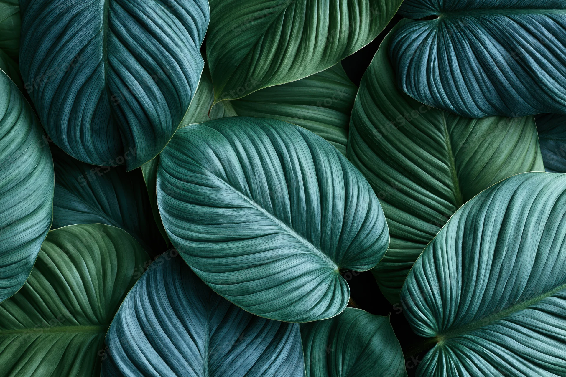 Dense tropical leaves filling the frame in a seamless pattern