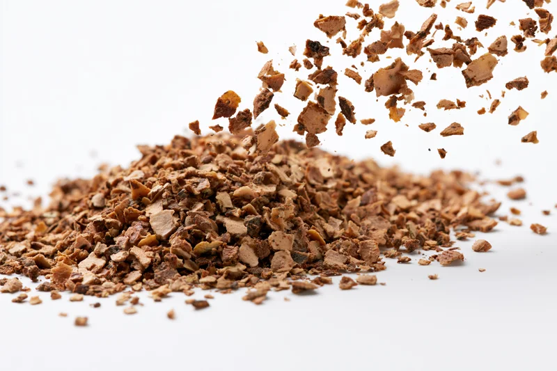 Dried herb flakes falling and piling on white background